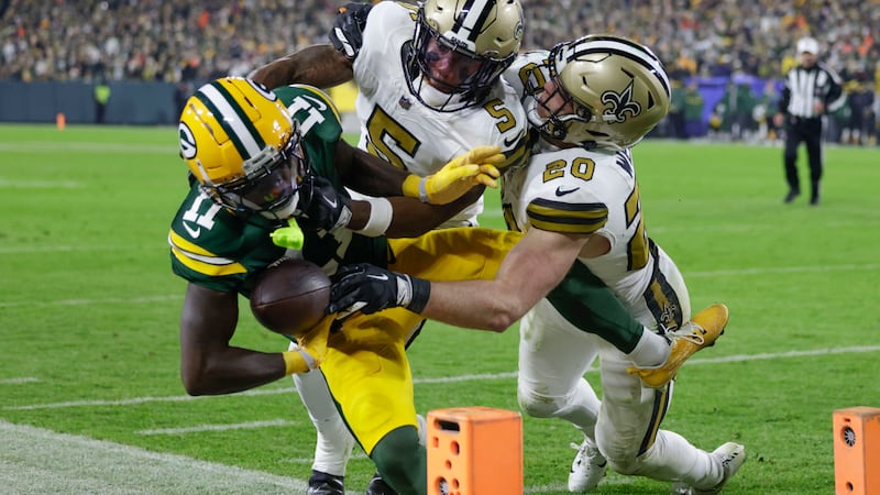 Green Bay Packers wide receiver Jayden Reed (11) is pushed out of bounds near the goal line by...