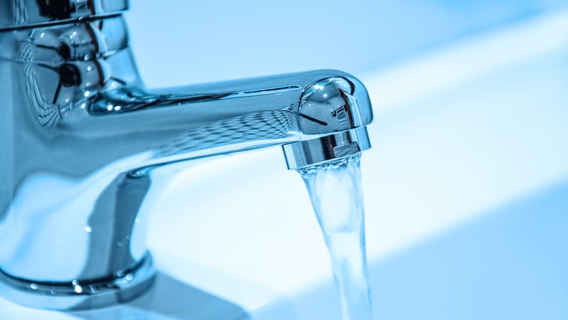FILE - Water running from an open faucet in close-up.