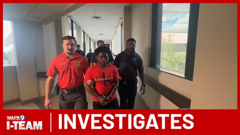 Baton Rouge police officers take Jeremiah Taylor into custody while investigating a...